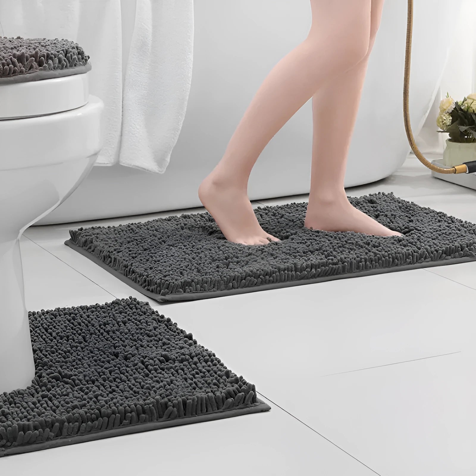 Chenille three-piece bathroom toilet mat set with U-shaped grey mat and rectangular mats on tiled floor.