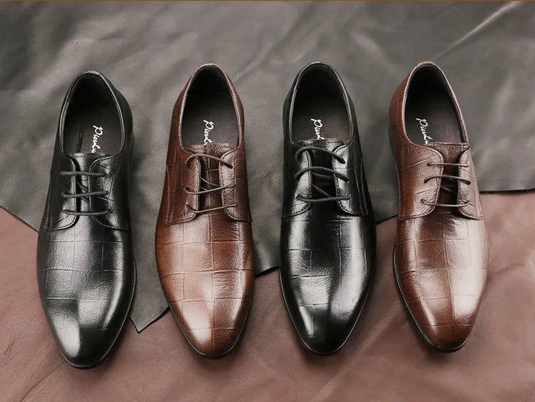 Men's black cow leather derby shoes with a pointed toe and rubber sole on a grey background.