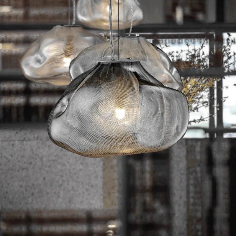 Modern fabric chandelier light with glass shade in amber, clear, or smoke grey, shown in small and large sizes.