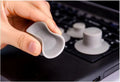 Grey plastic laptop cooling stand with four non-slip pads on a flat surface