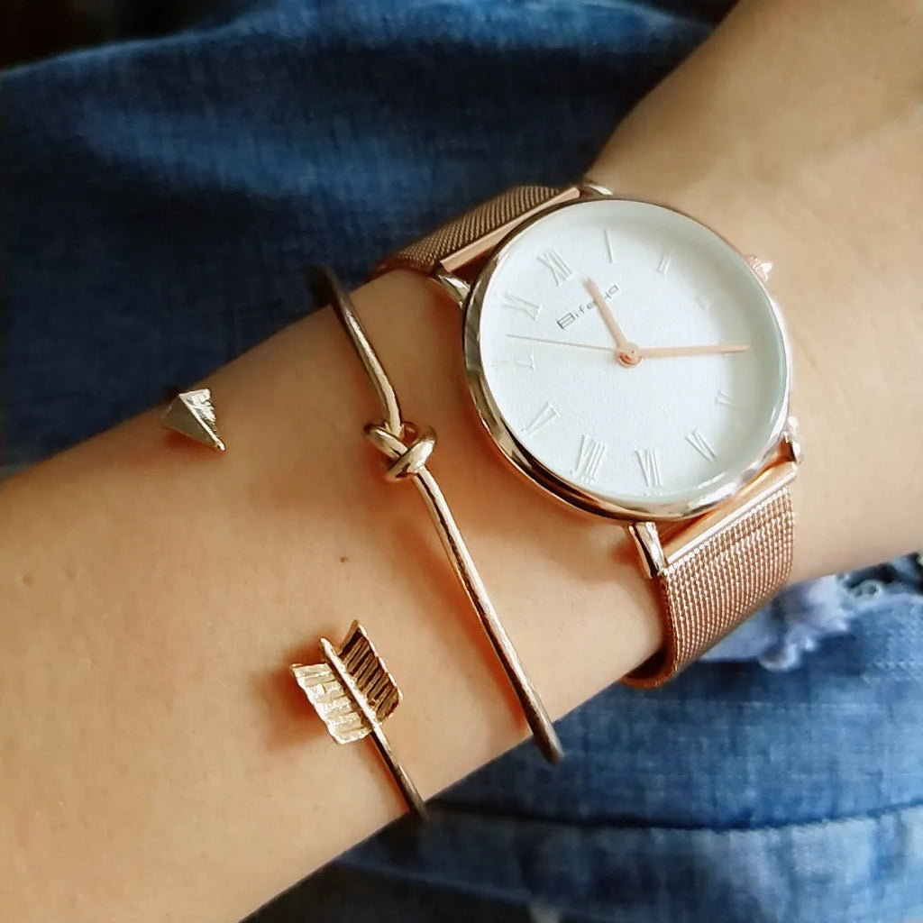 Gold electroplated vintage women's cuff bracelet with arrow and knotted design.
