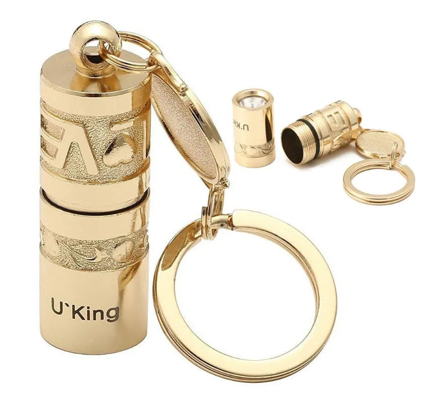 Gold zinc alloy LED flashlight attached to a keyring for outdoor and emergency use.
