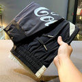 Black men's cropped casual trousers with ankle banding made from ultra-thin ice silk cotton fabric.