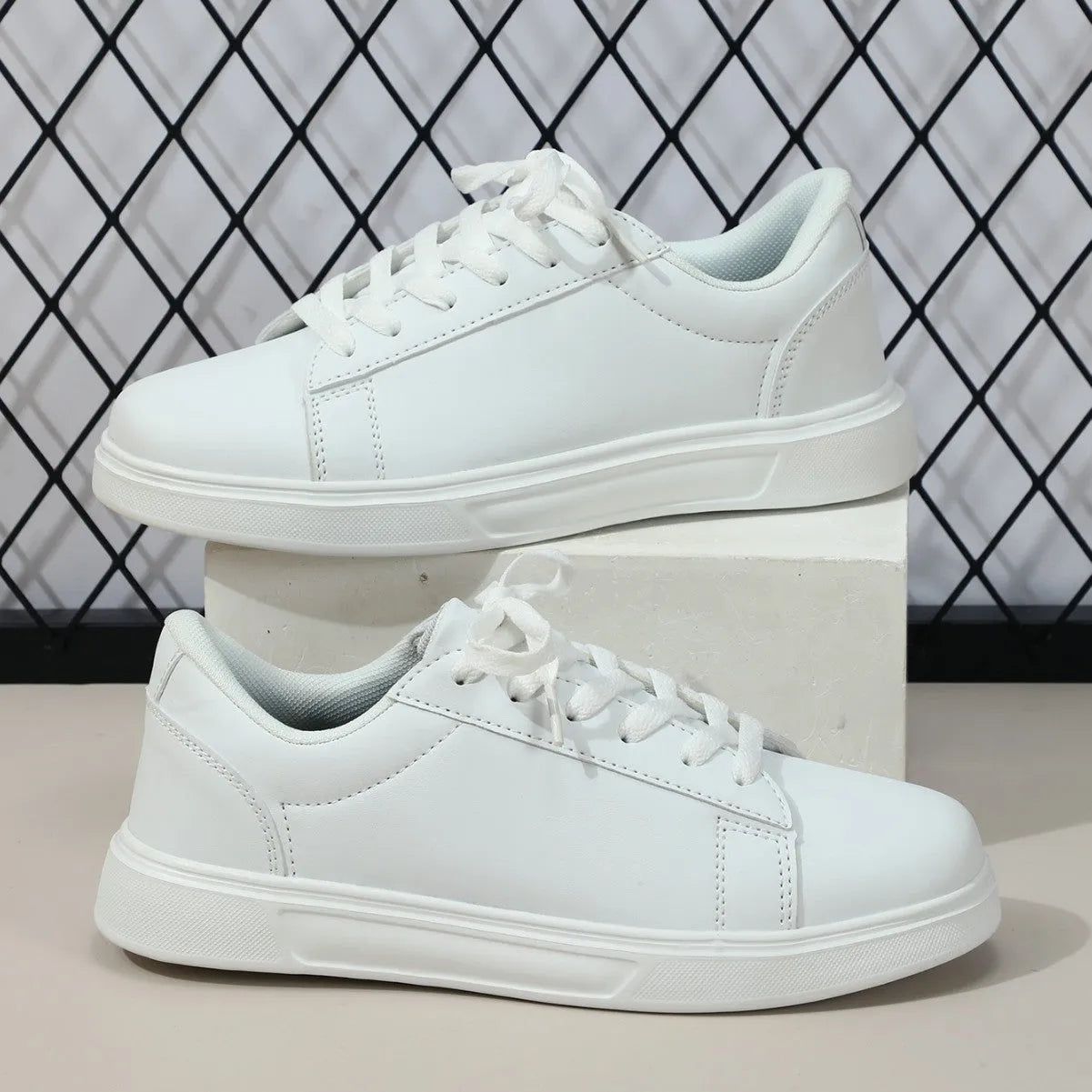 Beige brown casual platform sneakers with cross strap detail and rubber sole.