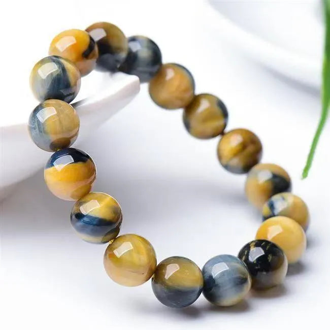 Fantasy Tiger Eye agate bracelet with round beads in a single circle design on a wrist.