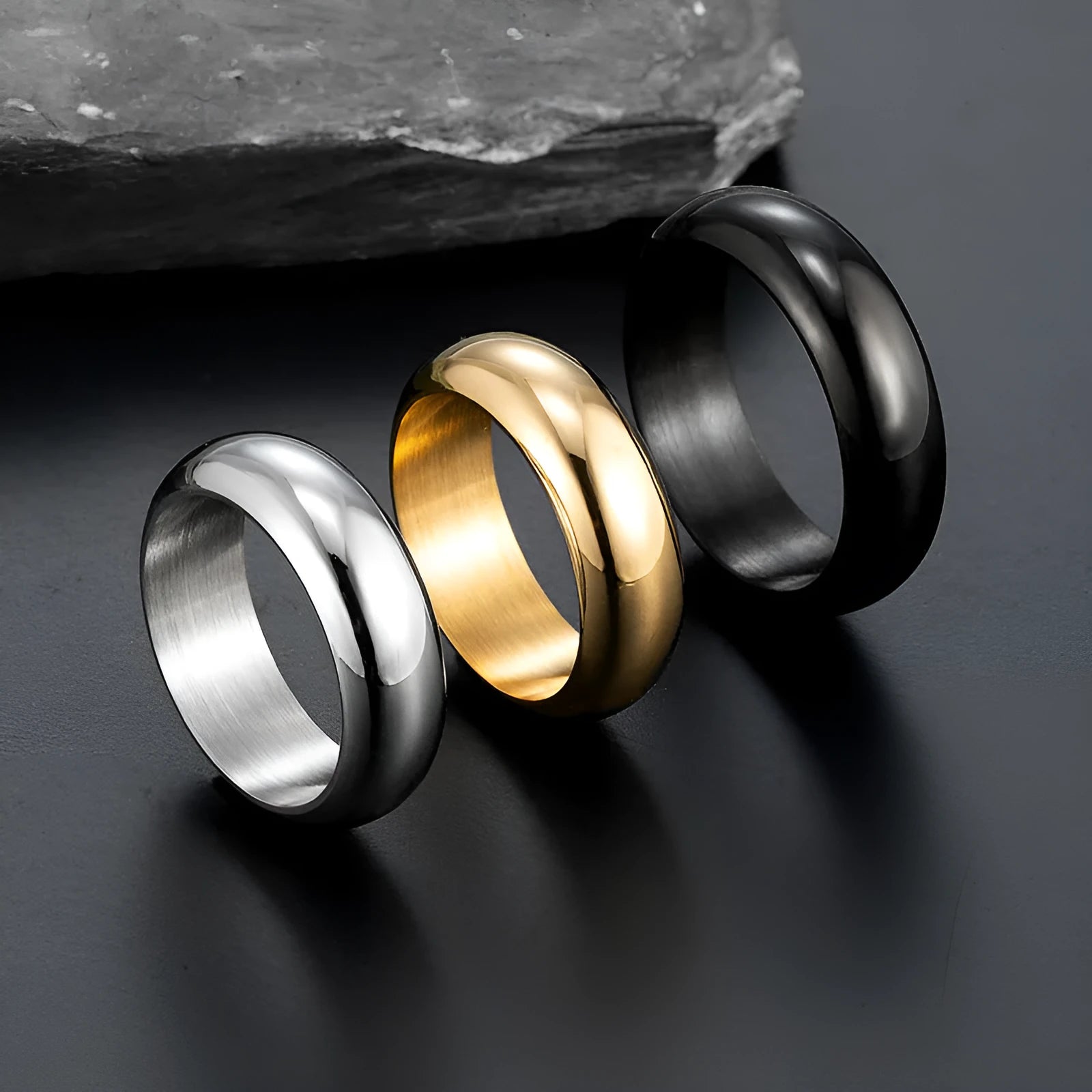 Glossy electroplated titanium steel ring shown in gold, black, and steel colours on size display