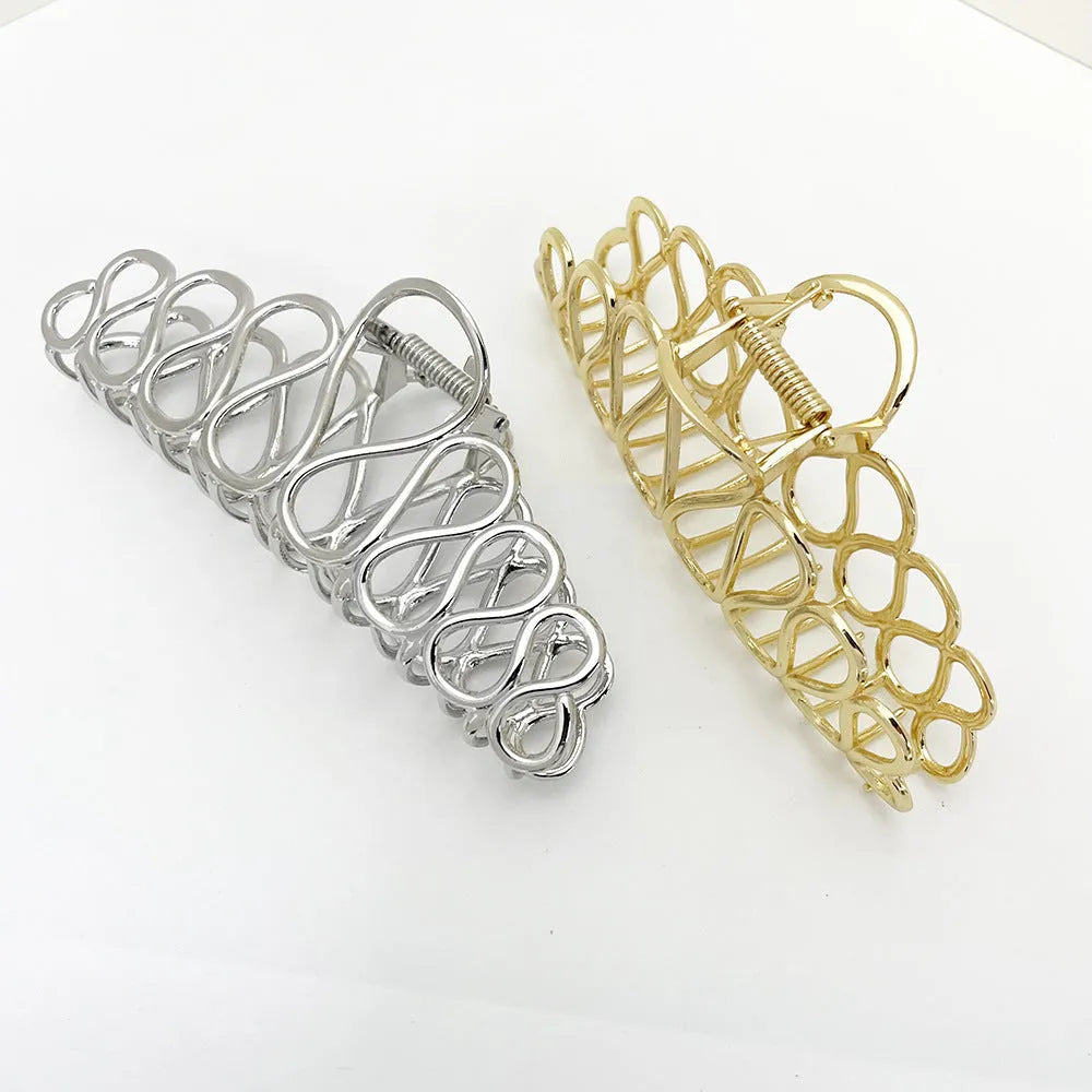 Minimalist large hair clip with electroplated alloy construction and tassel accents in gold or silver colour