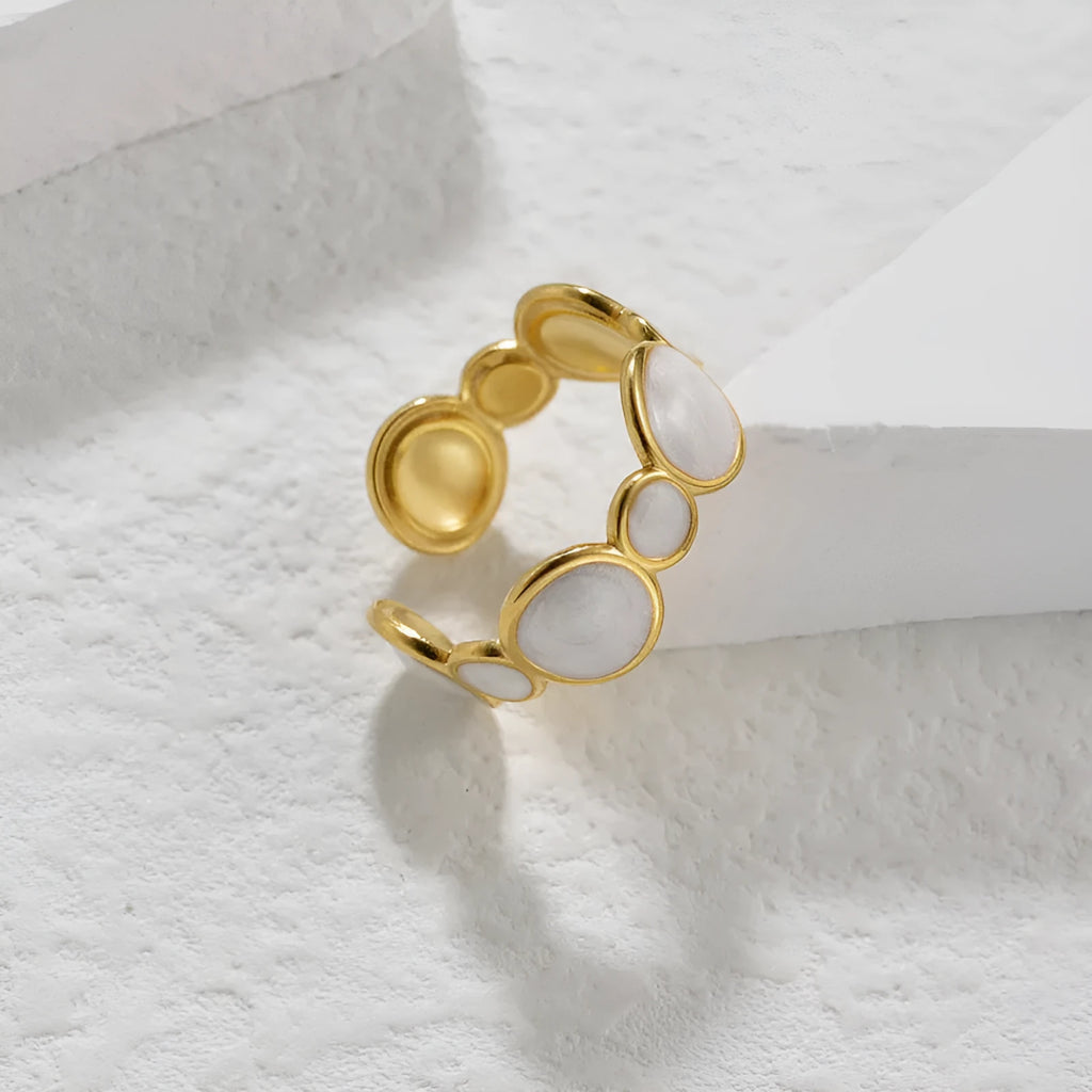 A geometric-shaped stainless steel ring with an adjustable opening on a plain background.