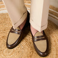 Coffee grey suede slip-on loafers with a rubber sole shown from the side.
