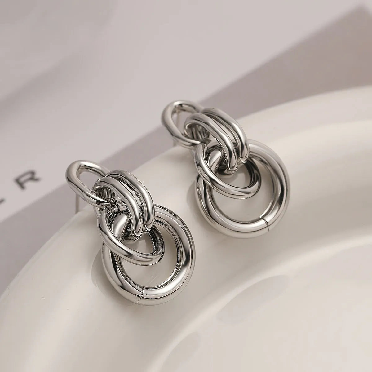 A pair of gold-coloured geometric earrings with an irregular, high-profile wild design for women.