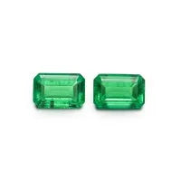 Polished cultivated emerald gemstone in Columbia green treasure colour showing various cuts including round and emerald cut.