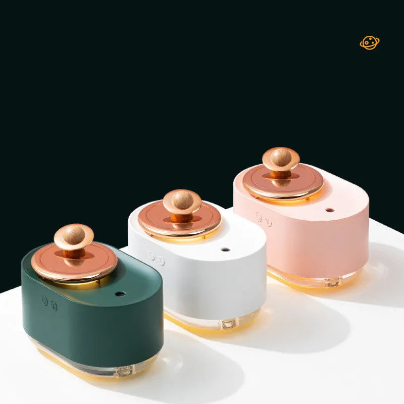 Green rotating planet-shaped desktop humidifier with night light on a wooden table.