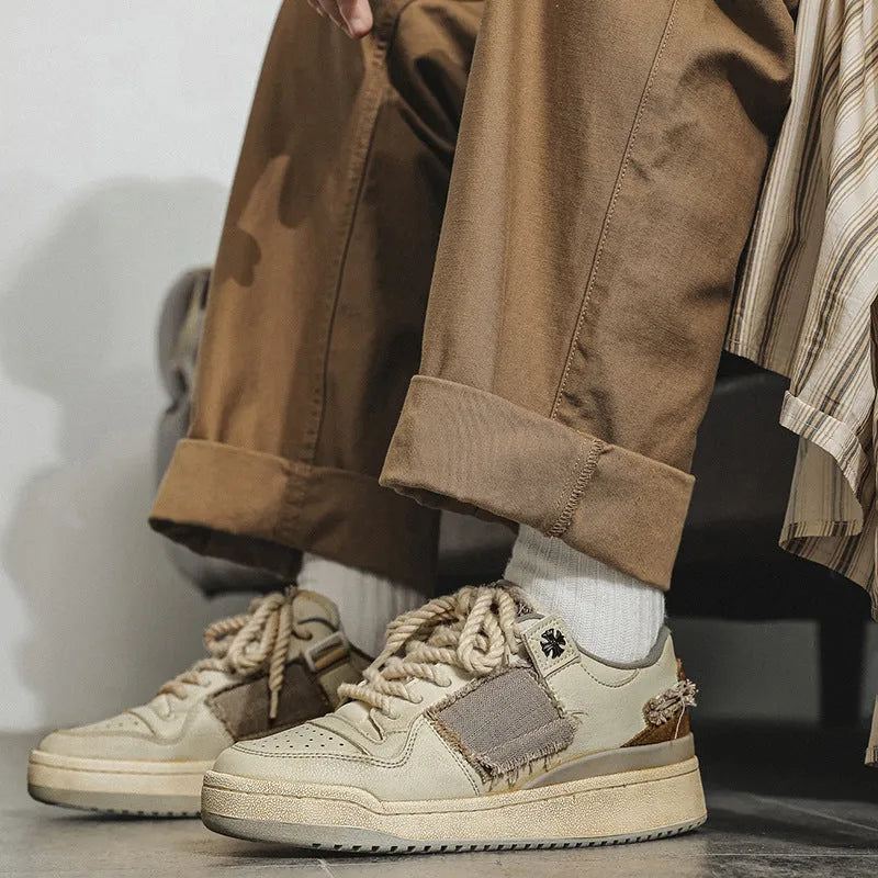 Beige vintage skateboard shoes with patch design, low-top cut, and round toe