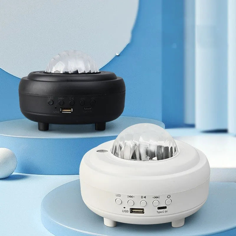 White galaxy star projector night light with Bluetooth speaker showing star projection on wall