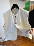 Beige loose-fitting cropped waistcoat dress with side pockets on a model.