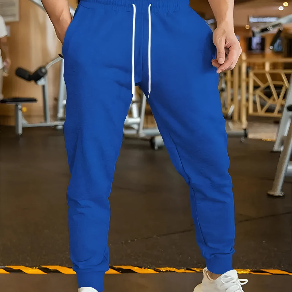 Men's elastic waist leisure trousers with drawstring closure and loose fit in polyester fabric