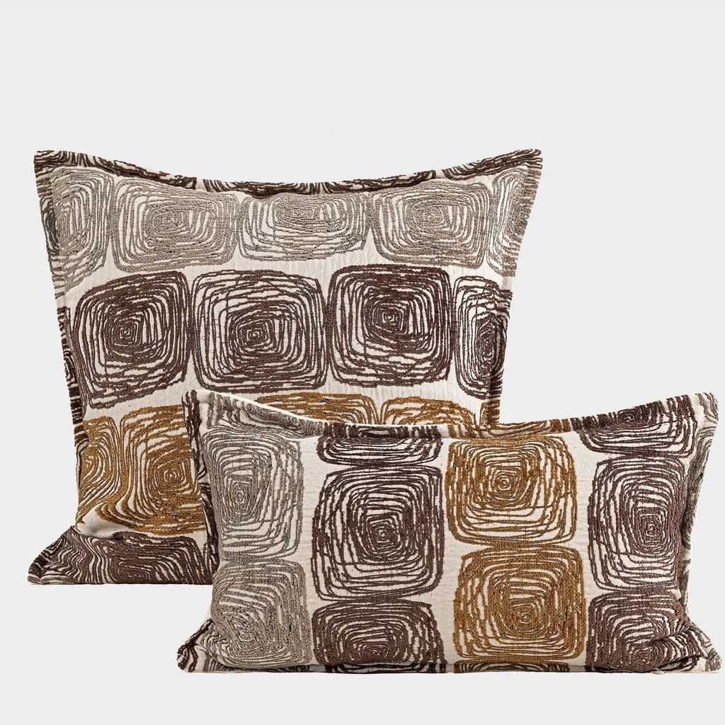 Cream and coffee-coloured abstract coil pattern printed on square polyester velvet pillow cover