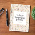 A5 pregnancy weekly diary notebook open showing weekly format pages