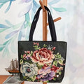 Double-sided embroidered canvas bag with gold wire detailing showing botanical pattern