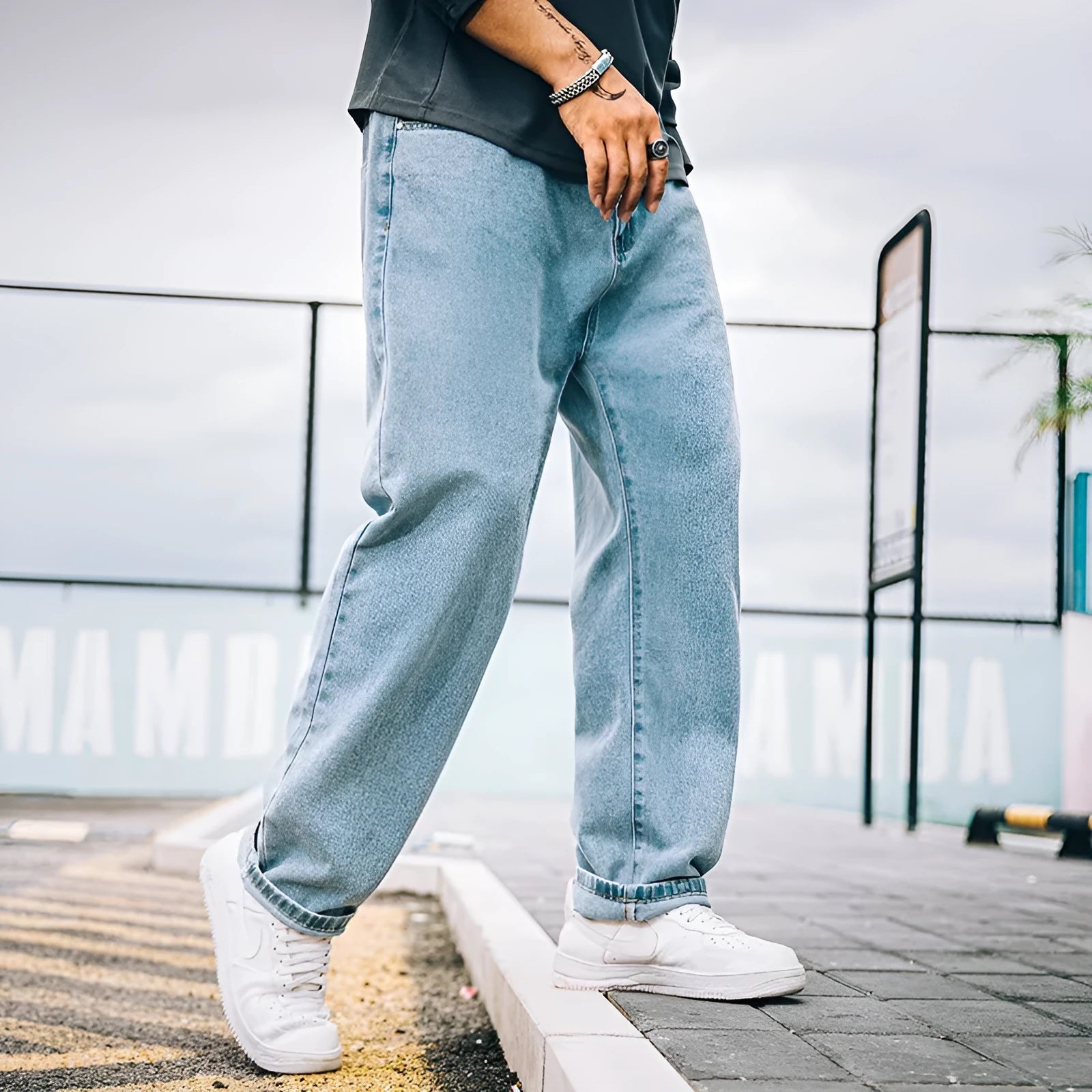 Men's loose fit straight leg jeans in cotton denim shown in dark blue, mid waist with zipper fly