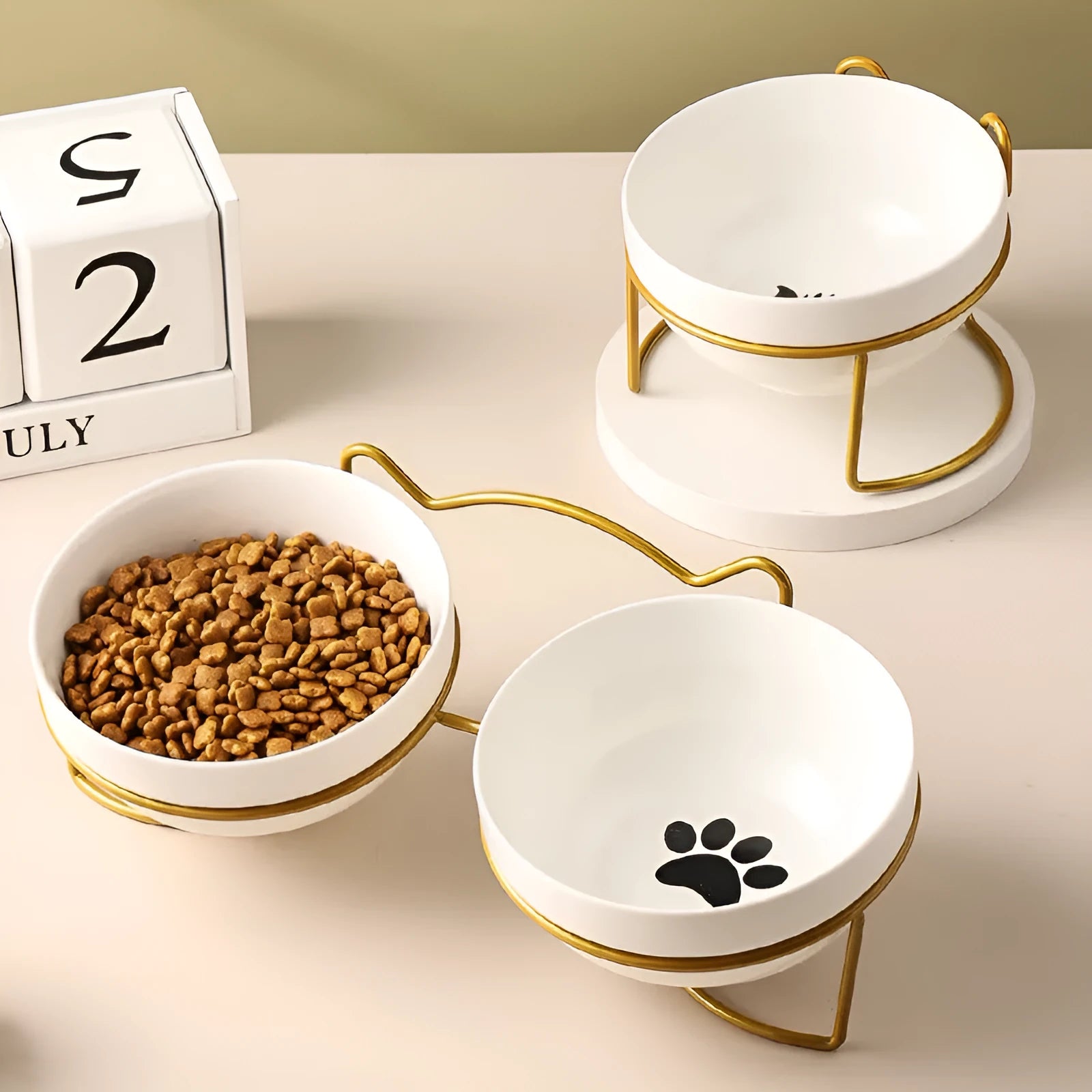 White ceramic cat bowl with cat paw print in a black iron frame stand with cat ears