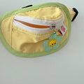 Pink and yellow backpack-style carrier for small dogs or cats, showing mesh panels and a poop bag holder.