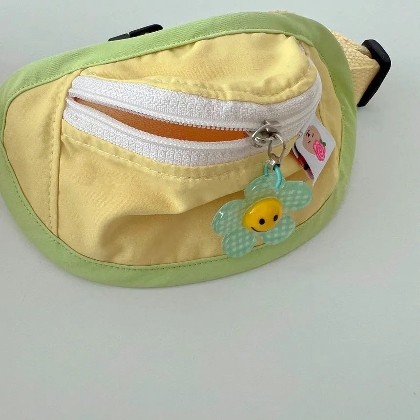 Pink and yellow backpack-style carrier for small dogs or cats, showing mesh panels and a poop bag holder.