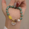Natural green jade and shell bead bracelet with adjustable cord for women.