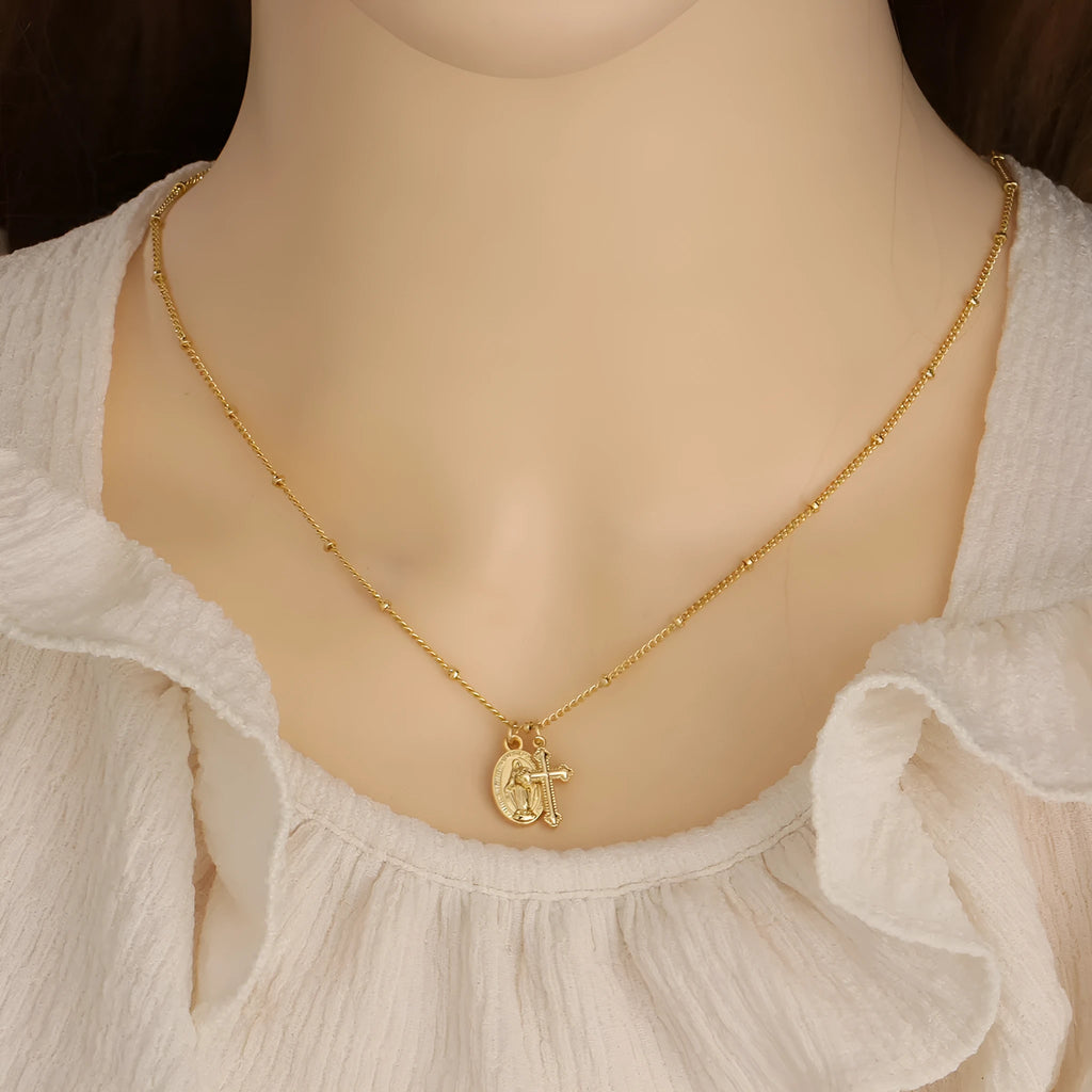 Virgin Mary geometric cross necklace in gold colour with simple styling