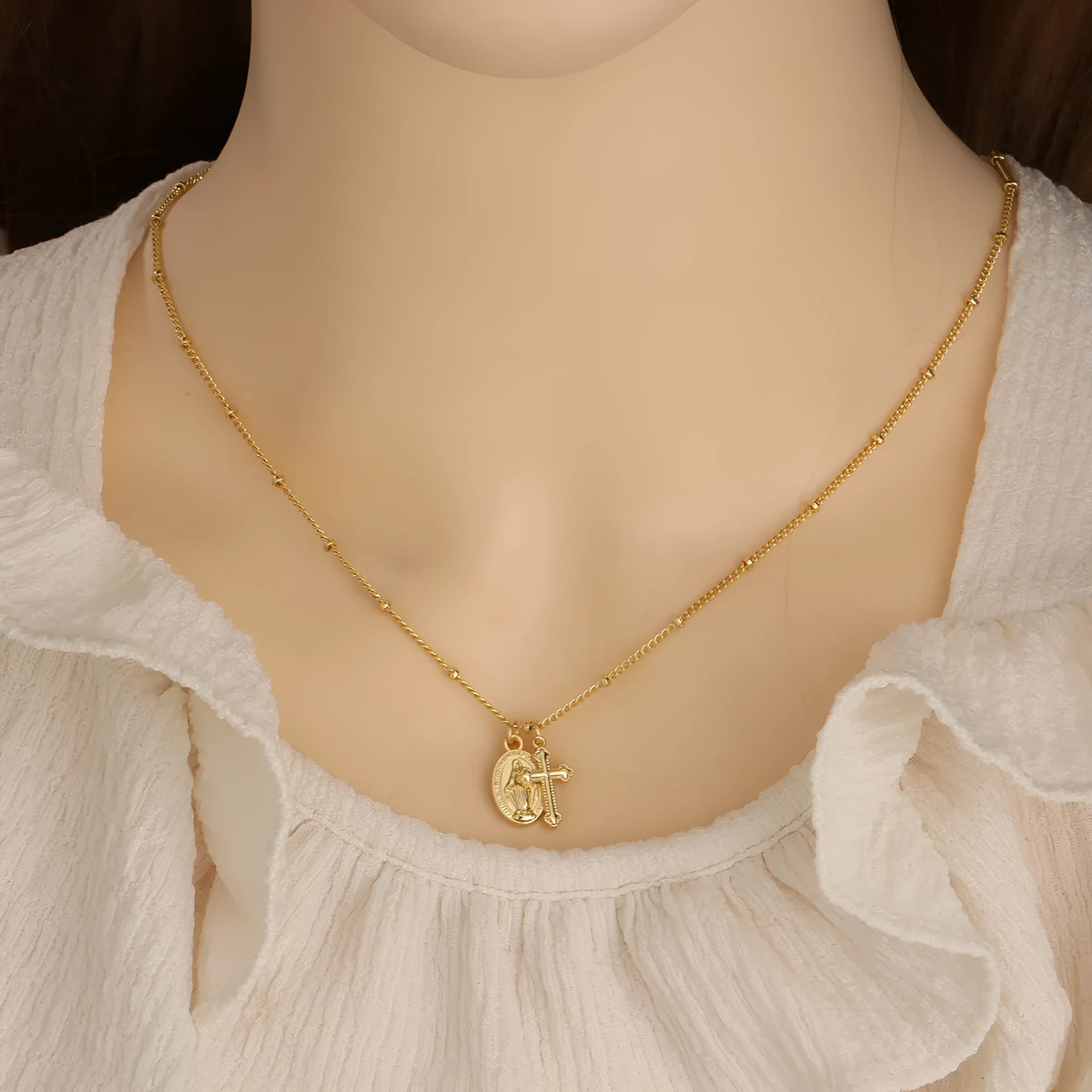 Virgin Mary geometric cross necklace in gold colour with simple styling