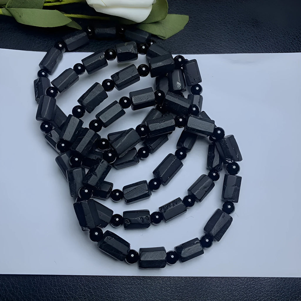 Natural black tourmaline rough stone bracelet with approximately 9mm beads on wrist
