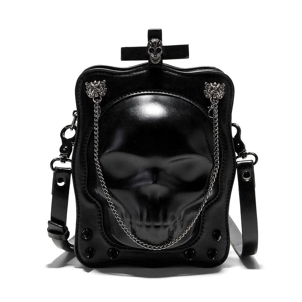 Black square crossbody bag with embossed skull design, chain accents, and zip opening