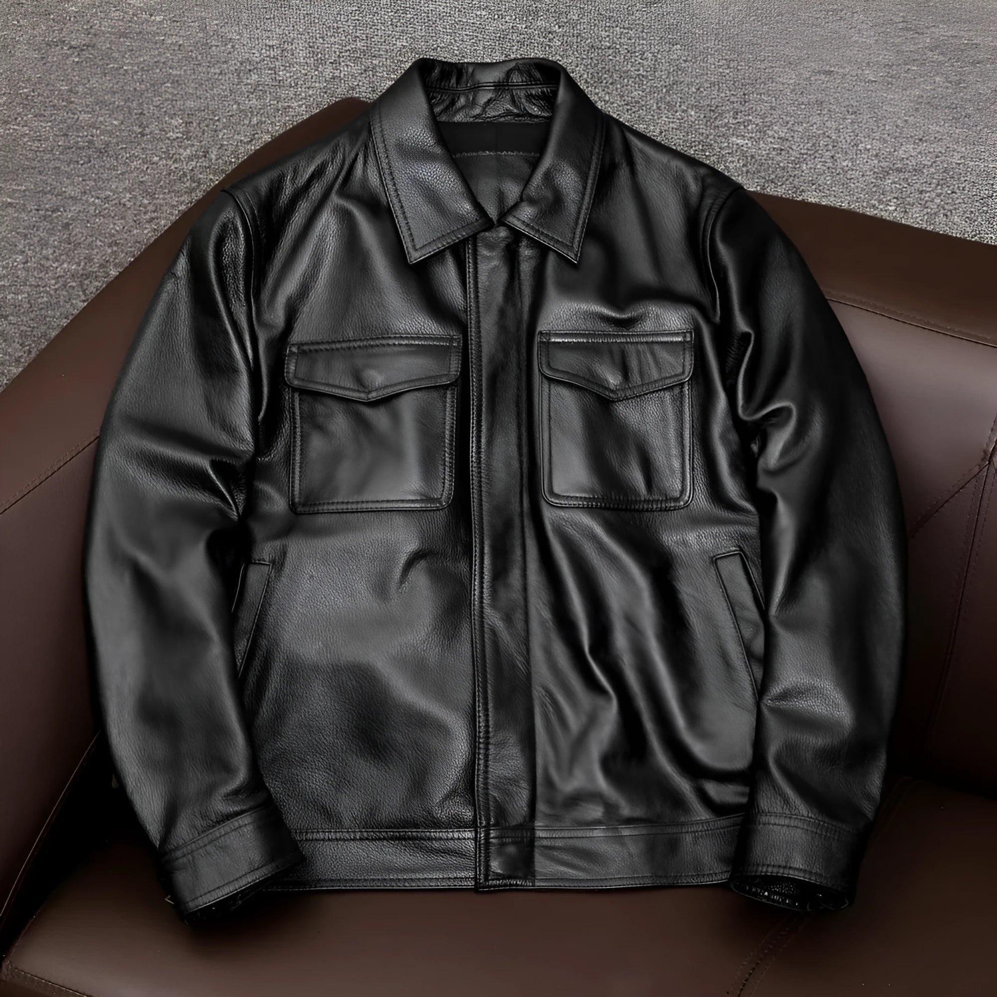 Men's black plus size PU leather jacket with lapel collar and side pockets on a hanger.