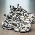 Men's black mesh platform sneaker with colour brush design and rubber sole.