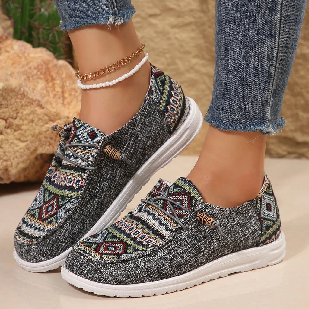 Women's flat slip-on shoes in black, dark grey, and khaki with round toe and rubber sole.