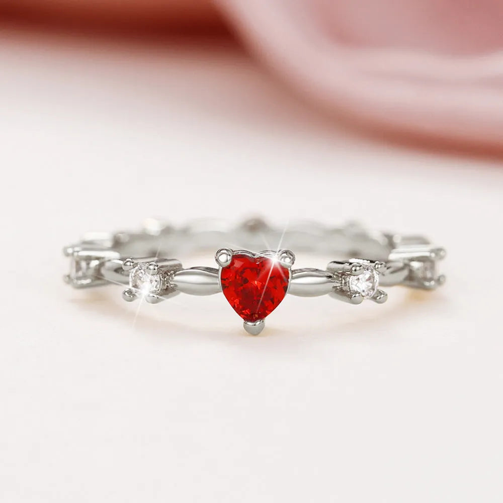 Gold or silver personalised zircon peach heart ring showing five available sizes on a ring sizer.