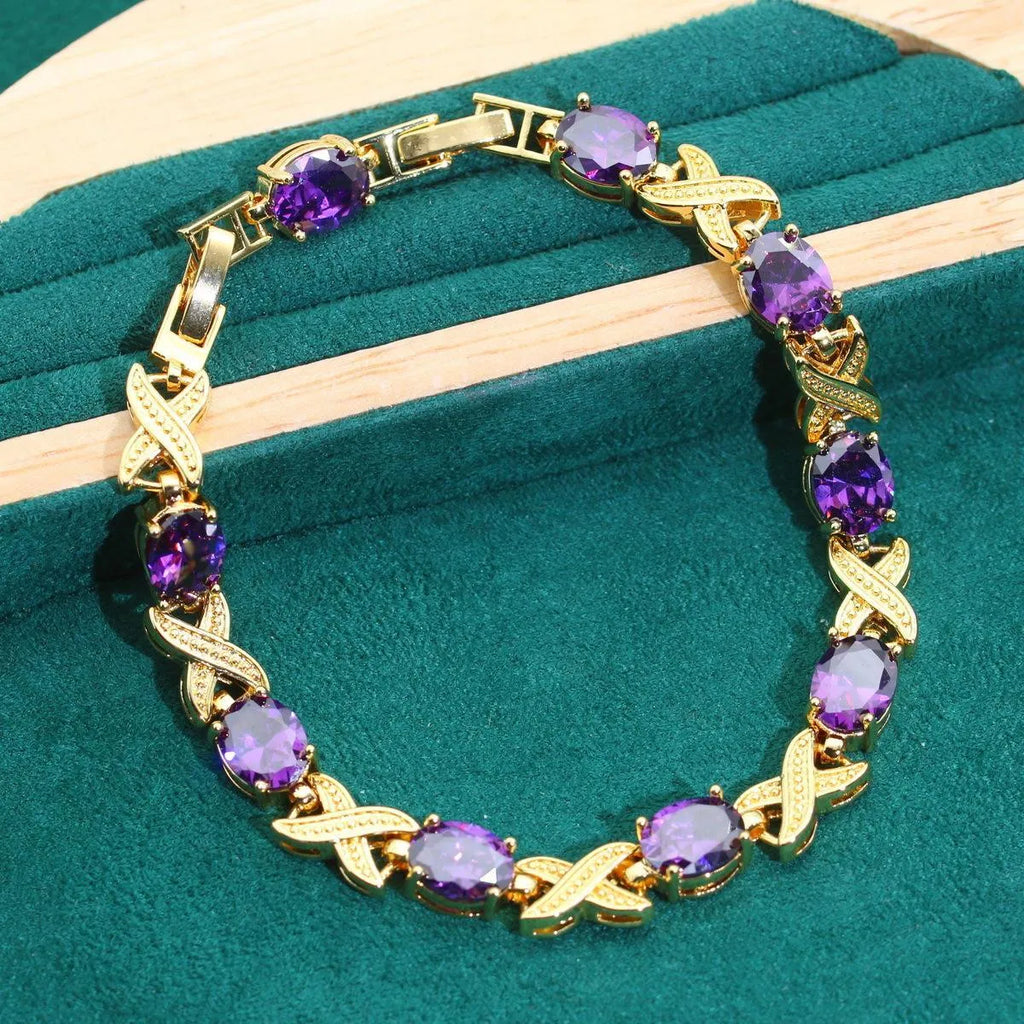 18k gold plated cubic zirconia jewellery set showing necklace, earrings, ring and bracelet in four colour options