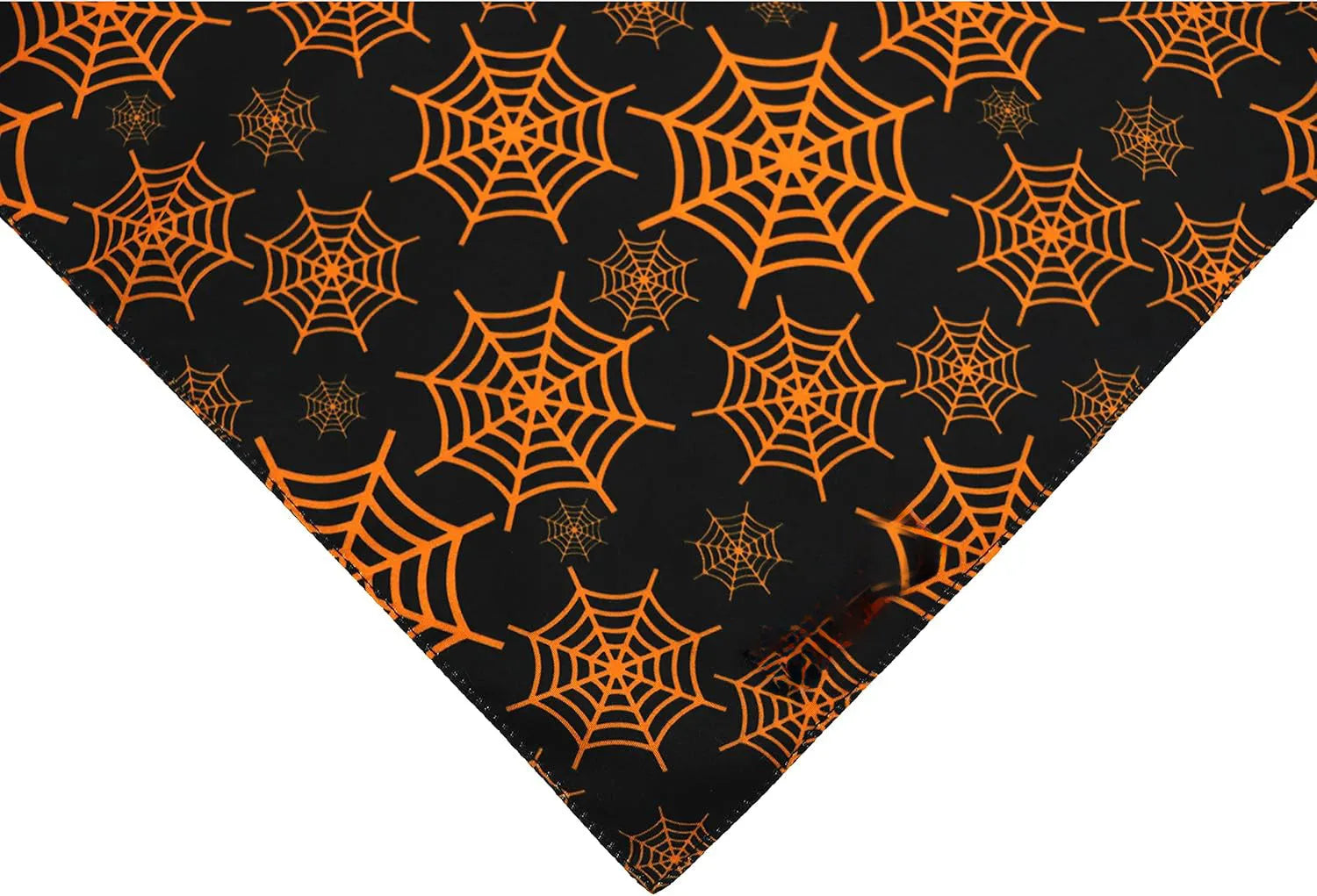 Reversible black and orange Halloween dog bandana with pumpkin and spider web patterns.