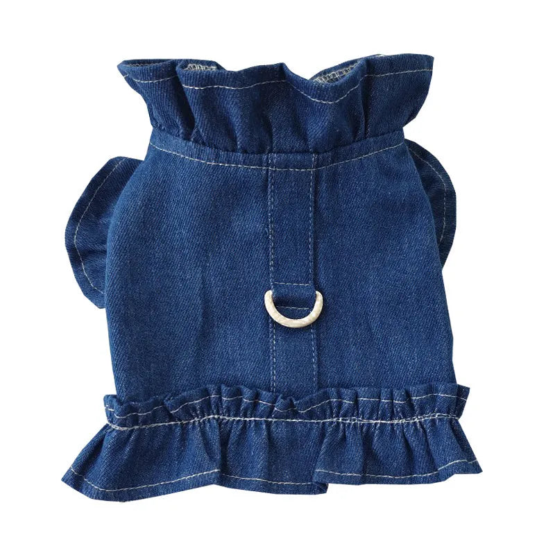 Blue denim dog dress with ruffle trim and back leash hook on a model dog