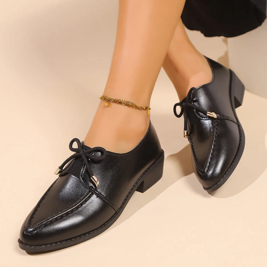 Women's British-style flat shoes with decorative bow, PU upper, and rubber sole in sizes 36-43.