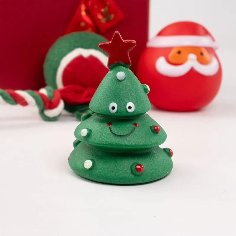 Set of vinyl Christmas-themed dog chew toys including balls, ropes, and Santa shapes in a gift bag.