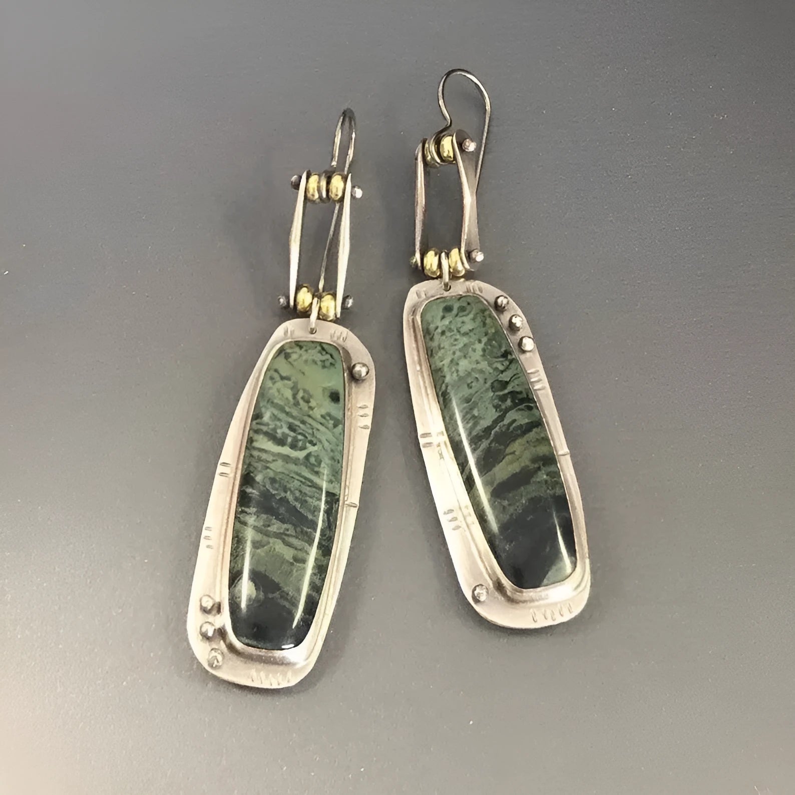 Geometric alloy earrings with two-colour marble pattern, showing angular shape and blended colour effect