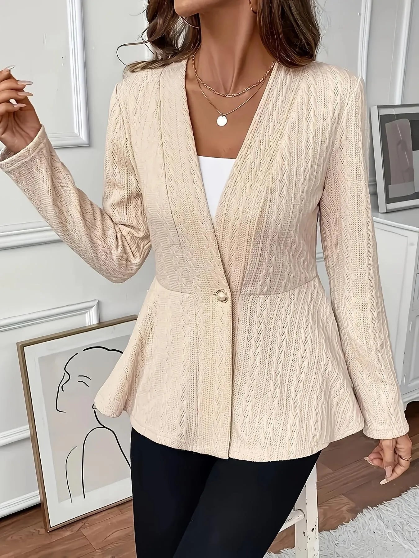 Women's apricot coloured Jacquard patterned knitted cardigan with one button front.