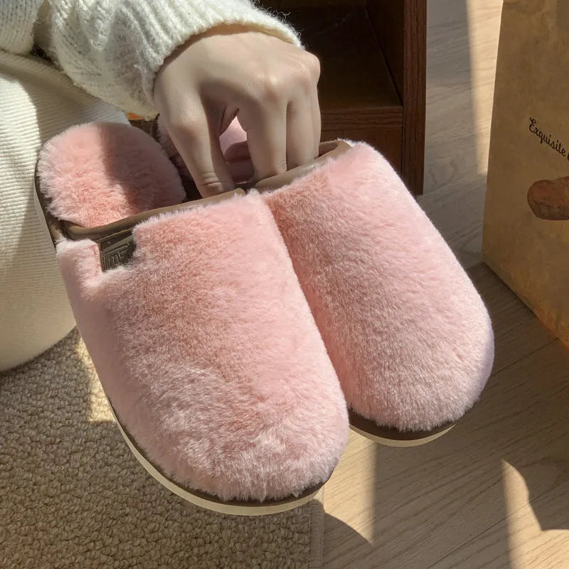 Winter plush slippers in blue colour with non-slip PVC soles, showing car stitching detail