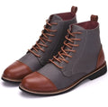 Large black leather motorcycle-style boots with metal belt buckle detailing on the shaft.