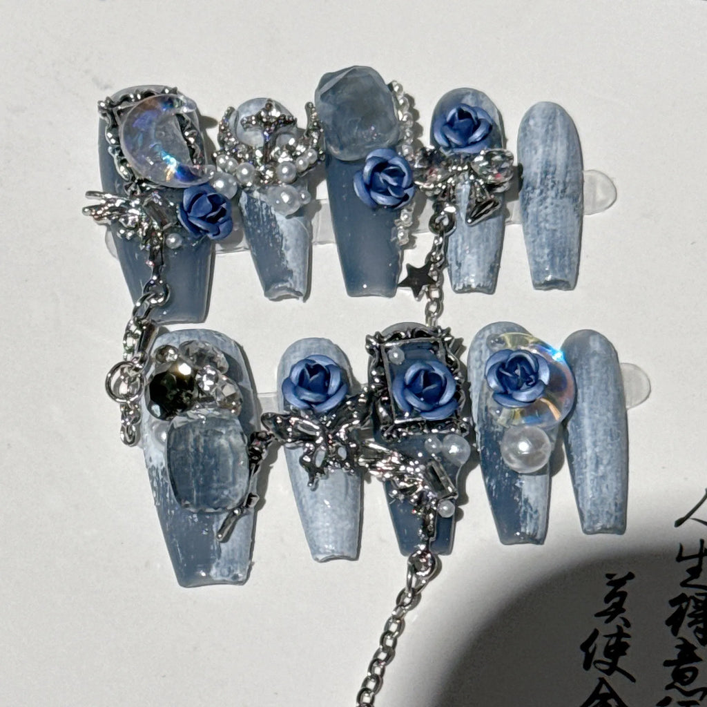 Heavy industry night blue false nails with ornate twinkling rose and tulip flower pattern.