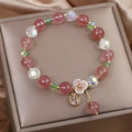 Women's double layer crystal bracelet with lucky cat charm and red cat's eye flowers.