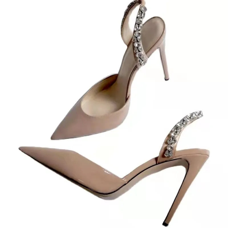 Women's black patent leather pointed toe stiletto sandals with rhinestone detail on the side, shown on a white background.