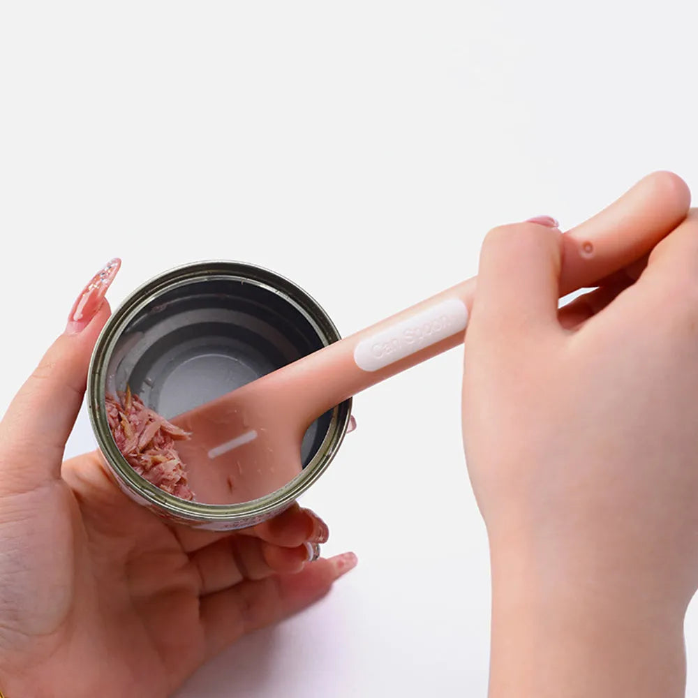 Green long-handled pet feeding spoon for scraping wet food from cans.