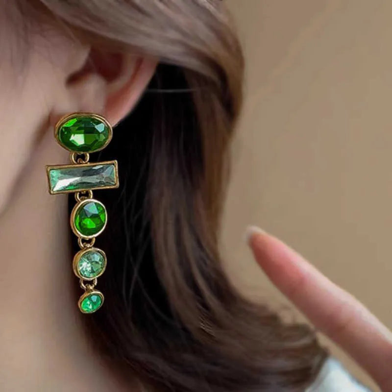 A pair of green gradient geometric alloy earrings with tassels and a zircon stone, shown on a white background.